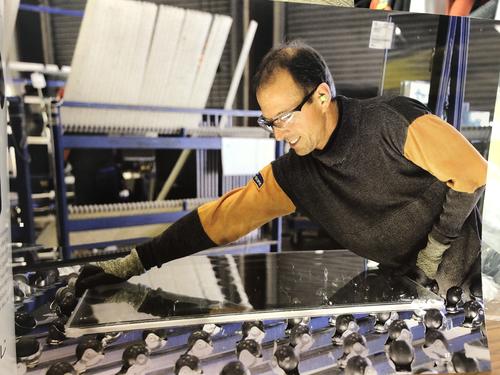 worker on fabrication line wearing PPE
